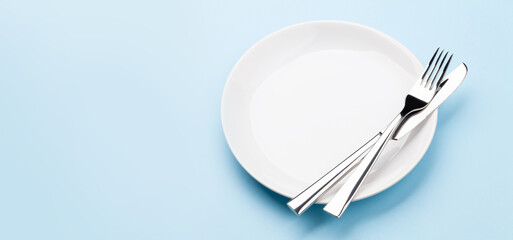 Empty plate, fork and knife