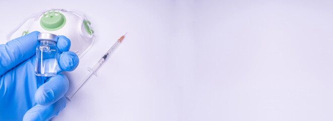 Covid 19 vaccine, immunity and medical treatment concept. Coronavirus syringe and needle. Doctor or nurse working in health care wearing a mask. Corona virus injection shot research.  Copy Space