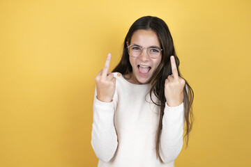 Beautiful child girl wearing casual clothes showing middle finger doing fuck you bad expression,...