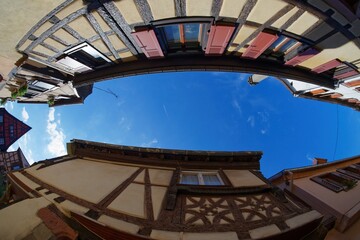 Fisheye view of the sky above a narrow street in Riquewihr town, Alsace, France