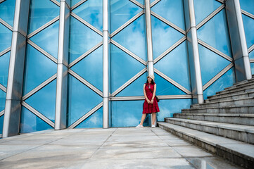 Asian woman in red dress at modern building, female girl with urban city lifestyle