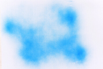 blue spray paint on white paper background
