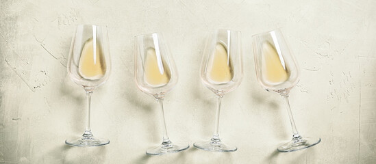 White wine in glasses on a concrete background, panorama. Top view, flat lay. - obrazy, fototapety, plakaty