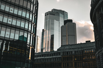 Obraz premium Tall Skyscrapers with Grey Sky with Small Office Blocks