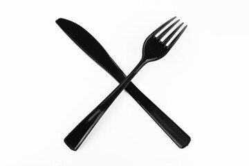 Black table fork and knife crossed on white background