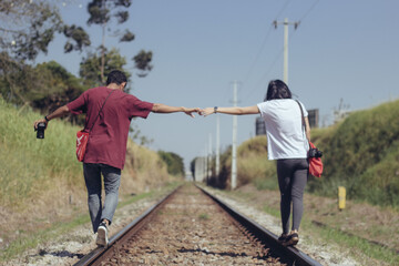 couple walking on a railroad