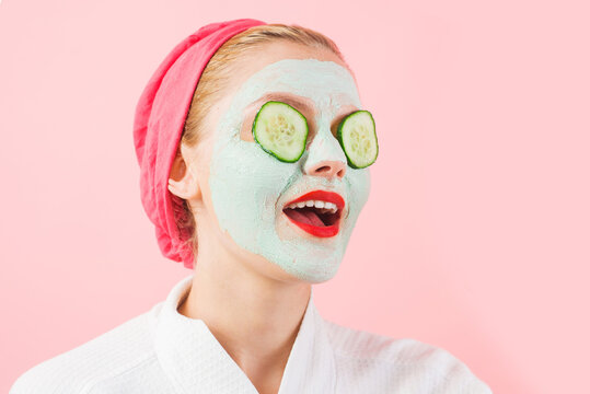 Woman with cosmetic mask on face. Cucumber slices on eyes. Female with facial mask. Beauty treatment. Spa therapy.