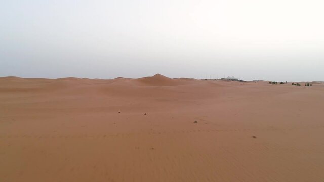 Aerial view of the desert dunes near village.