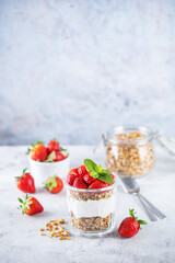Strawberry Greek yogurt granola parfait in a glass