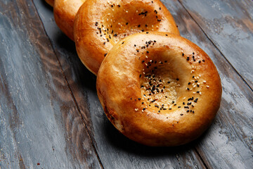 National uzbek bread on wood background. Traditional food. Top view