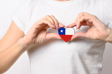 Love Chile. On her chest, the girl holds a heart in the form of the flag of Chile. Chilean Concept...