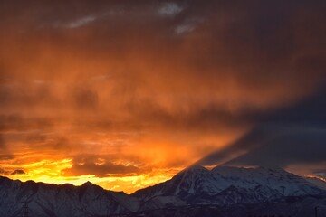 Sunrise view of winter panorama. Snow capped Mt Timpanogos in the Wasatch Front Rocky Mountains, Great Salt Lake Valley and Cloudscape. Provo, Utah, United States.