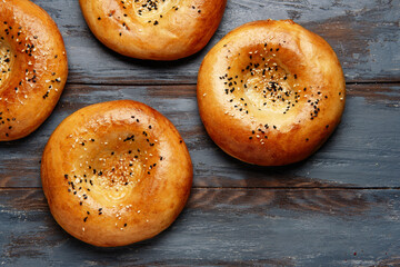 National uzbek bread on wood background. Traditional food. Top view