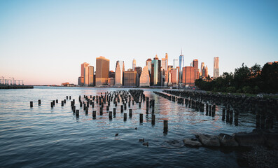 new york city panorama pier reflections water buildings skyscrapers woods sea sun sky light blue 