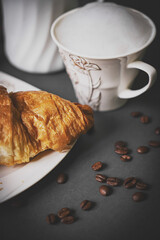 Top view of coffee and croissant with coffee bean
