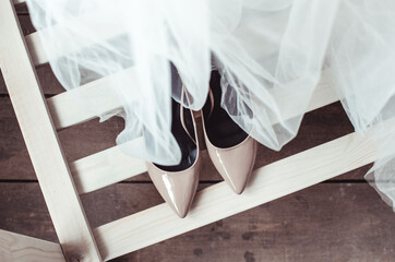 Fototapeta na wymiar wedding shoes and the dress made of tulle top view