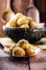 cod dumplings, fish meat dumpling in a slotted spoon, fried salty