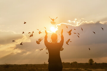 Doves fly towards the Sun during prayer.