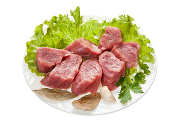 Pieces of raw meat on a white plate is isolated on a white background