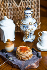 Delicious pancakes with red caviar. Russian and Ukrainian cuisine. The concept of the Maslenitsa...
