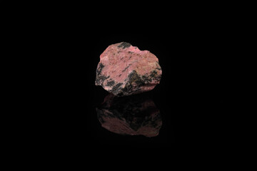 Natural mineral rock specimen - rough rhodonite stone from M. Sidelnikovo, Ural, Russia on black...