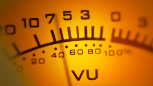 Close up shot of a highlighted analog VU audio meter