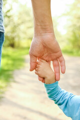 the parent holding the child's hand with a happy background