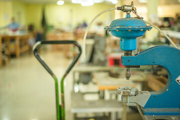 equipment in a bag factory, punching machine for leather products,  machine for processing leather parts for bags, work in a factory, the process of making accessories