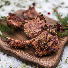 Doe or deer rack on a wooden board decorated with lingonberries and sprigs of spruce.