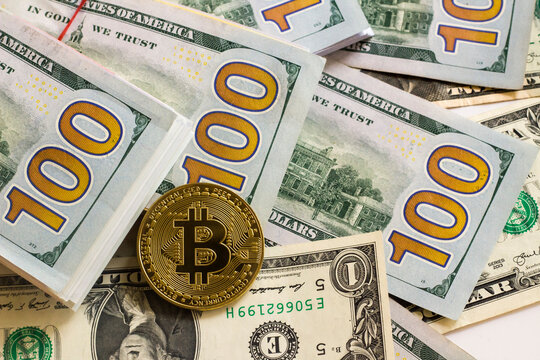 Metal bitcoin cripto money on American dollar banknotes,above view
