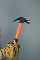 Repair man hand with hummer 