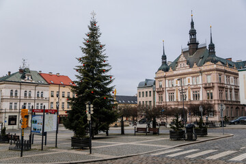Neo-renaissance house of Ceska sporitelna and Fountain, Christmas tree, baroque historical buildings, Square of Bohemian Paradise in winter day, Turnov, Czech Republic