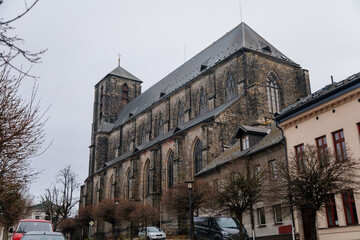 Fototapeta premium Gothic stone church of the Nativity of the Virgin Mary in winter day, cityscape of medieval town with historical buildings, Bohemian Paradise, Turnov, Czech Republic