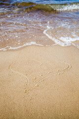 heart is drawn on the sand