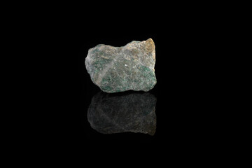 Natural rock specimens - green listvenite, listwanite mineral from Berezovsk, Ural, Russia on black glass background.