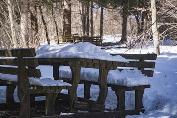 snow covred the bench in the mountains