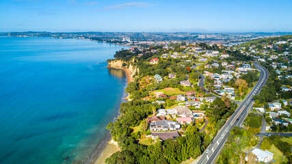 Aerial view of a beautiful suburb on the shore of a quiet harbour on a sunny morning. Auckland, New...