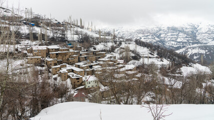 Hizan, Bitlis, Turkey - February 2020: Remote village in Eastern Turkey Anatolia with stone houses, snowy landscape, Hizan, Bitlis, Turkey
