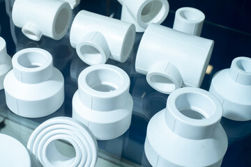 Fittings for polypropylene pipes. Elements for pipelines. White plastic piping elements. They are designed for connecting pipes. Concept - sale of polypropylene fittings. Fittings production