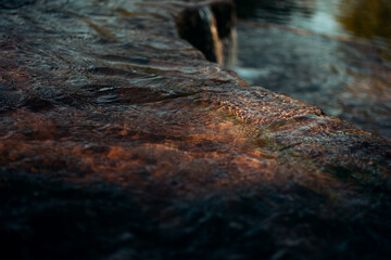 Water flowing illuminated by a ray of sunlight 