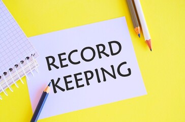 Record keeping text written on a white paper with pencils. Conceptual photo The activity or occupation of keeping records or accounts.