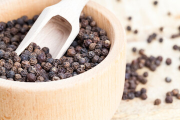 spice black pepper scattered on an old wooden table