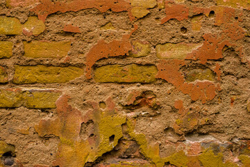 old stone wall of a house with plaster