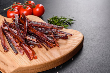 Tasty hearty meat salted and dried with pieces of spices and herbs