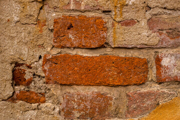 old brick wall of a house with plaster
