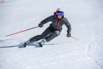 Young  woman skiing on a sunny day in Andorra.