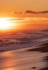 wave breaking on the beach forming white foam