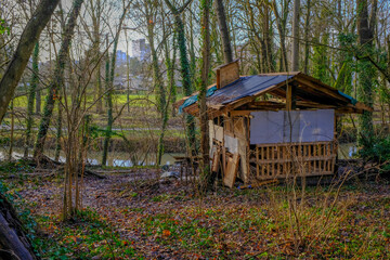 Dilapidated shack on the edge of a small river