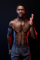 Fototapeta na wymiar confident black sportsman running, isolated on black background. muscular strong male engaged in sport, have athletic body