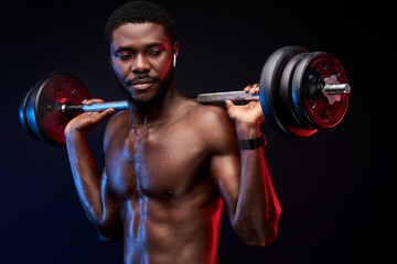 Fototapeta na wymiar african american bodybuilder with weights in hands, wearing headphones. weightlifting and sport concept.